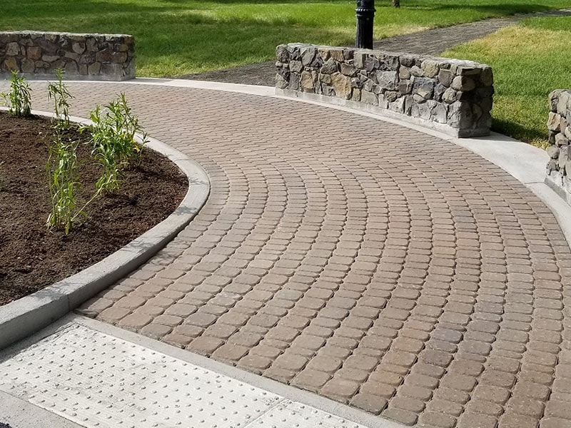 Curved circular paver patio with a soldier-course border installed by Elite Hardscapes in Spokane, WA