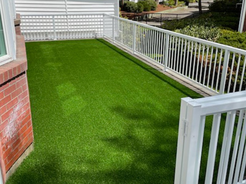 White vinyl privacy fence enclosing a manicured lawn, installed by Elite Hardscapes in Spokane, WA