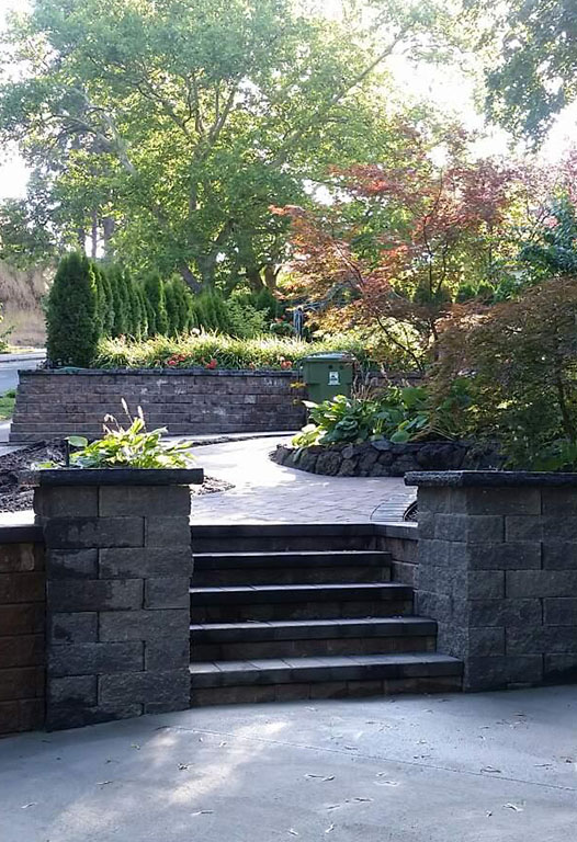 Elite Hardscapes crew finishing a paver patio at a Spokane home